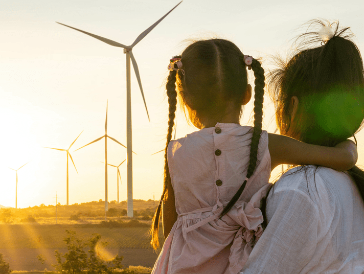 Women with child looking at windmill