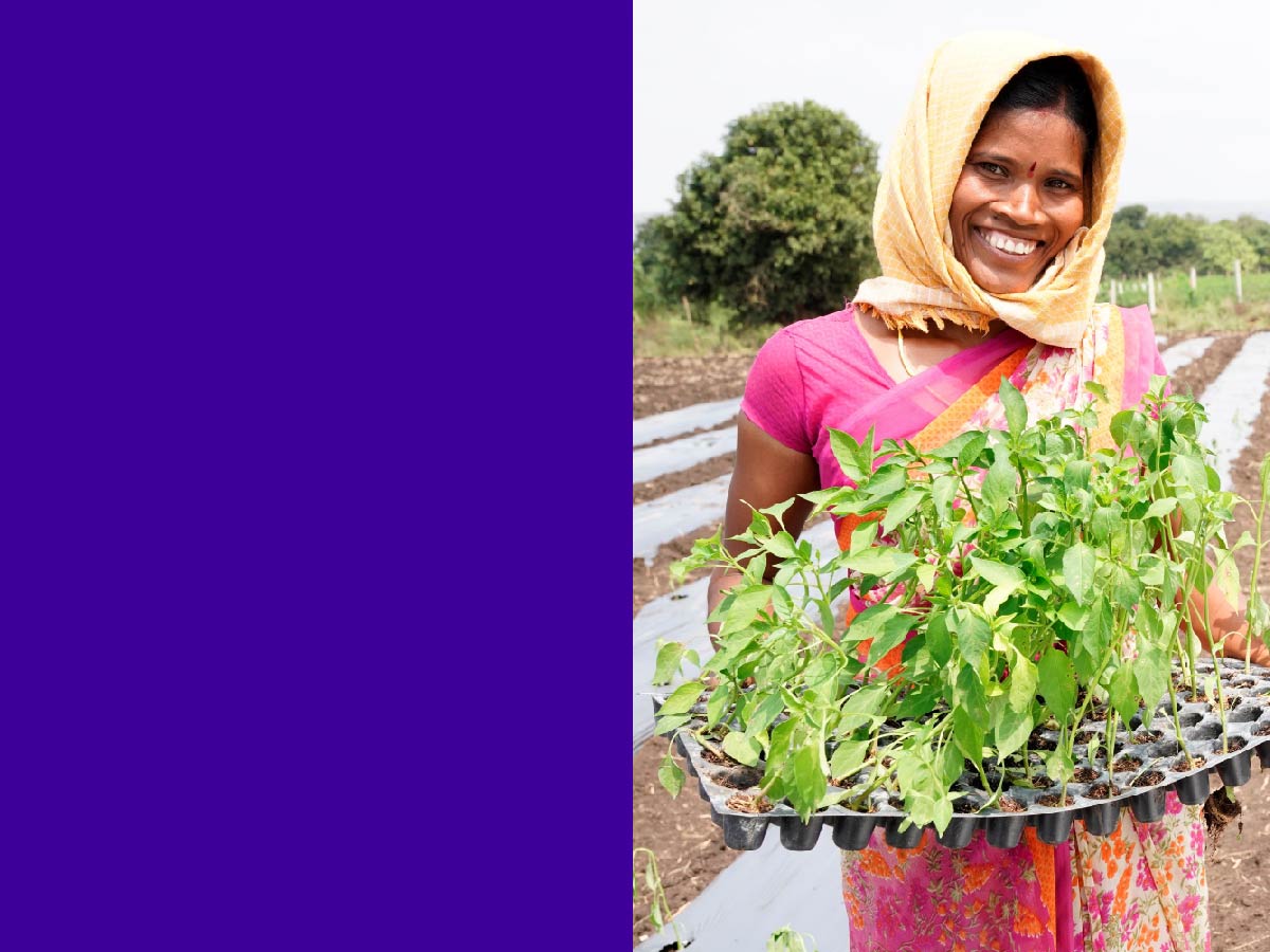 smiling female farmer holding herbs