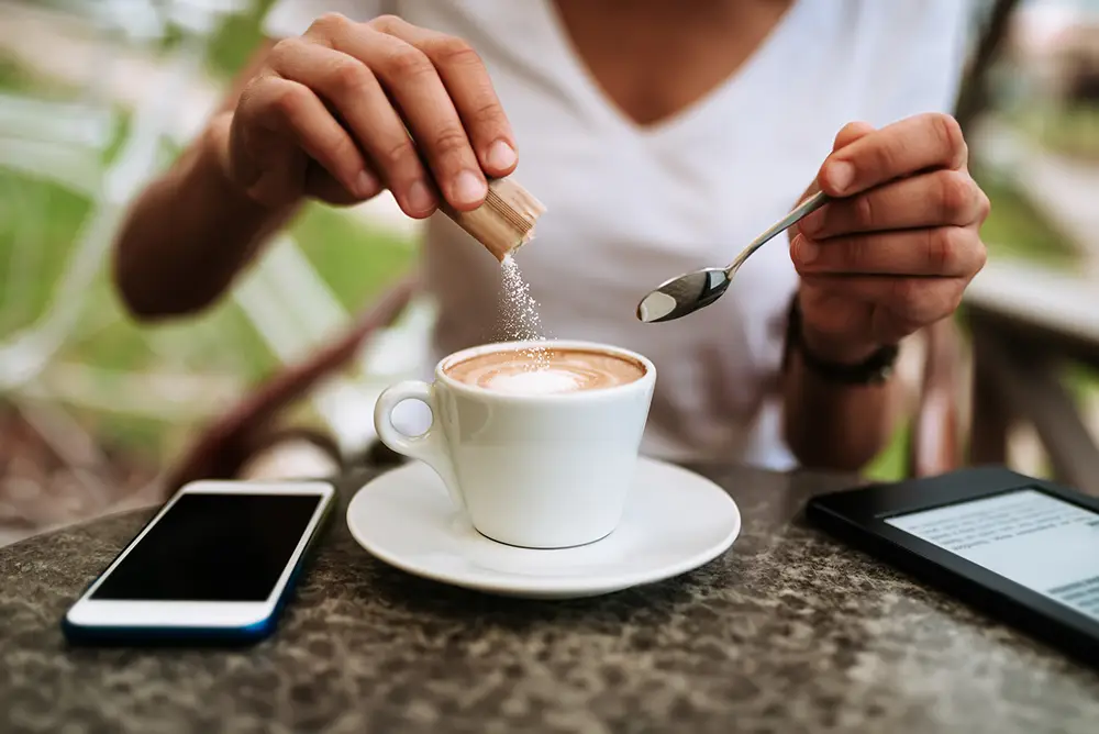 consumer-diner-putting-sugar-in-coffee