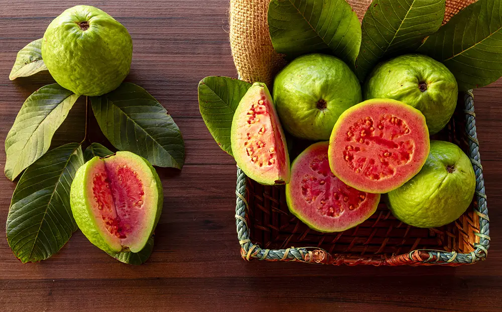 guava-in-basket-on-wood-table-close-up